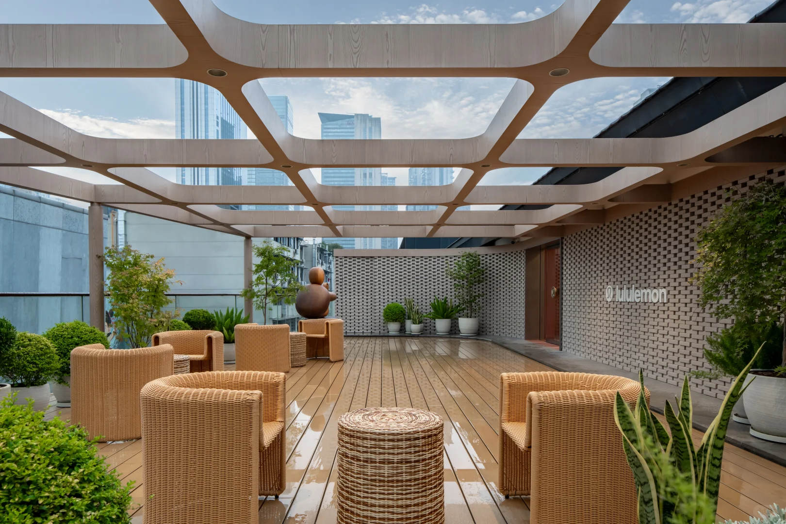 Planted terrace with woven seating and a lululemon sign at Chengdu Taikoo Li