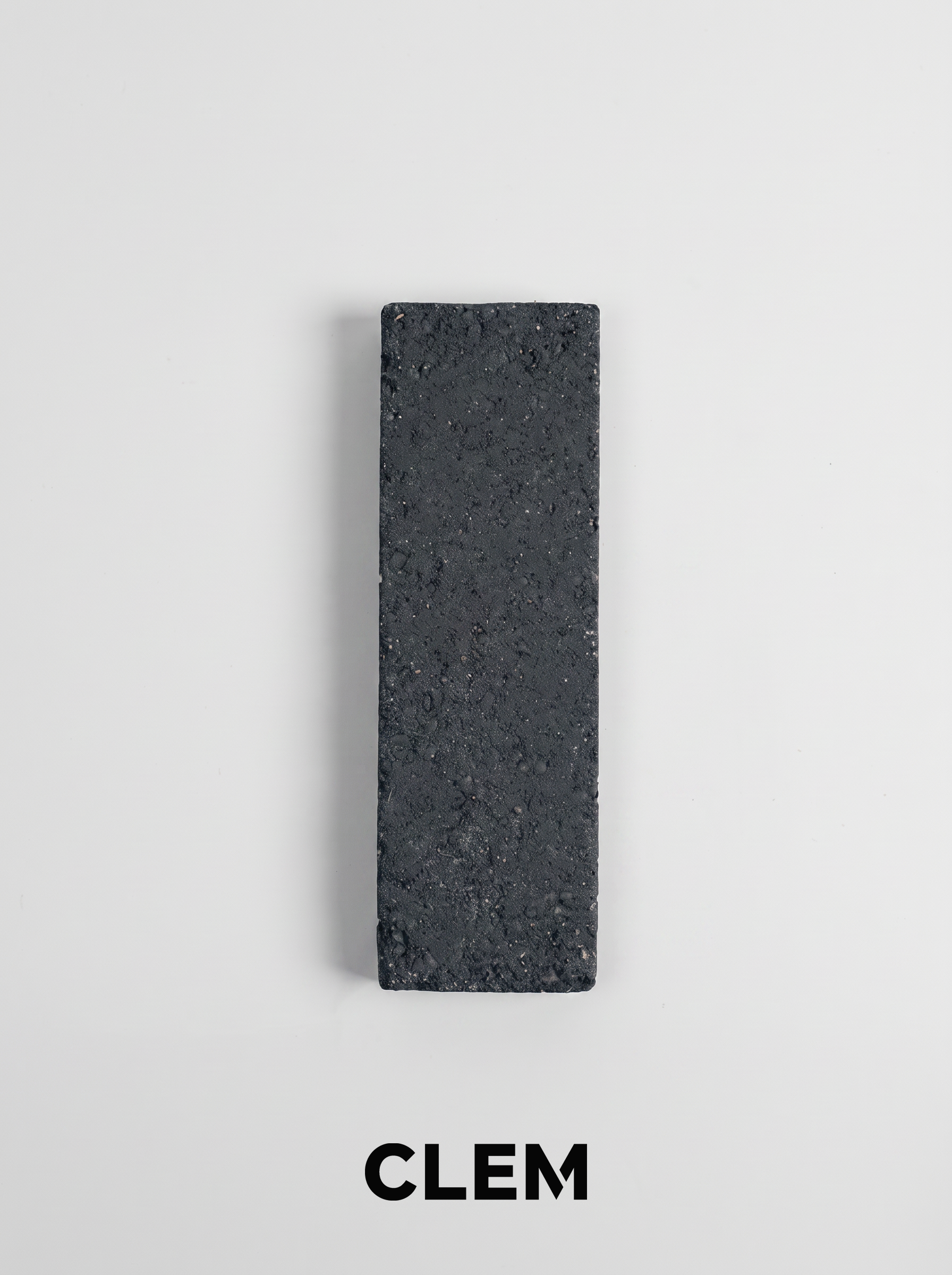 C08  Charcoal Black recycled tile sample by CLEM Stone Tiles on a neutral background