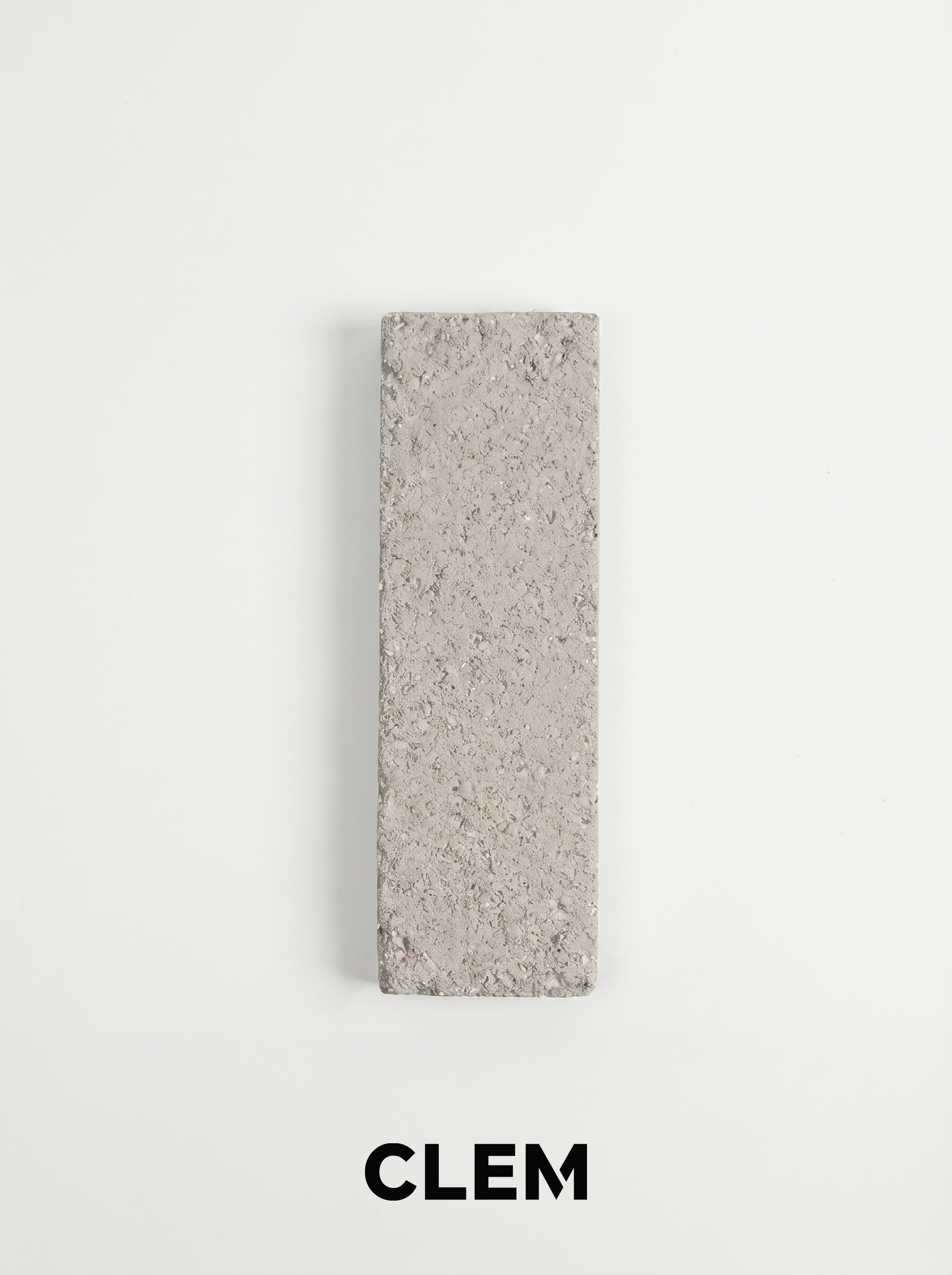 C20 Ivory Stone recycled tile sample by CLEM Stone Tiles on a neutral background